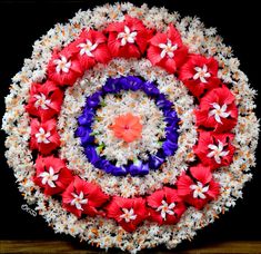 a wreath made out of white and red flowers