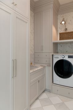 a washer and dryer in a white laundry room