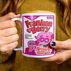 a woman holding a coffee mug with a cereal ad on it