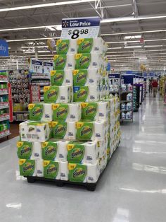 a display in a grocery store filled with lots of toilet paper and cleaning wipes