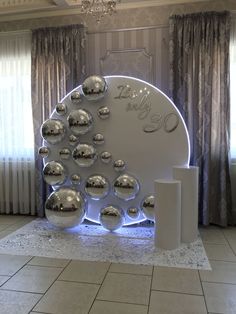 a large white display with silver balls on it