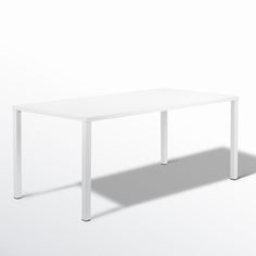 a white table on a white background with the shadow of it's legs in the foreground