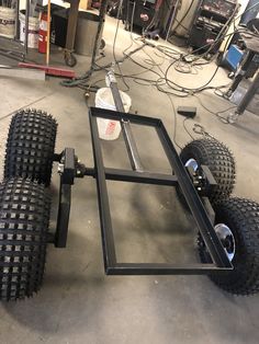 a trailer with wheels and tires in a garage