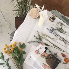 flowers, candles and pictures on a table