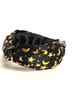 Moon & Stars Celestial Knotted Headband perfect to wear to the April 8, 2024 Eclipse! Celestial Knotted Headband designed by Knot and Crown. Style - the ever chic and popular Top Knot. Quality fabric print with gold moons and stars. Black satin covered headband. Comfy Lightweight Width approx. 2.5" Fits most Signature Crown Charm  Handmade USA Complete satisfaction Star Headband, Gold Moon, Turban Headbands, Knot Headband, Top Knot, Black Satin, Hair Accessories Headbands, Stars And Moon, Printing On Fabric