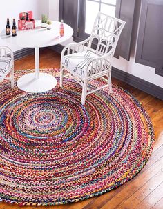 a living room area with a rug, table and chairs