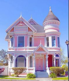 a pink victorian style house on a sunny day