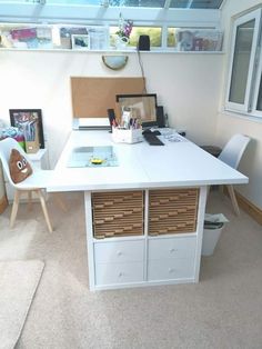 a white desk with drawers under a skylight