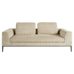 a beige couch sitting on top of a white floor