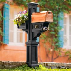 a mailbox with flowers in it on a post