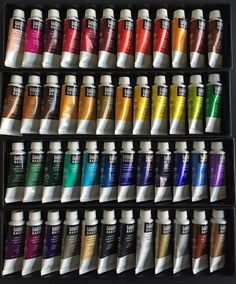 a display case filled with lots of different colors of paint