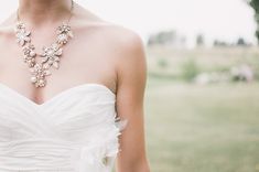 a woman in a white dress with a necklace on her neck and the words event planning written across it