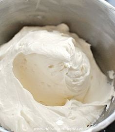 a bowl filled with white cream sitting on top of a table