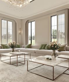 a living room with couches, tables and chandelier