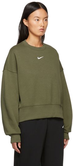 Long sleeve cotton-blend fleece sweatshirt in green. Rib knit crewneck collar, cuffs, and cropped hem. Logo embroidered in white at front. Supplier color: Medium olive/White Nike Oversized Sweatshirt, Nike Phoenix Fleece, Nike Crewneck Sweatshirt, Crewneck Sweatshirt Women, Oversized Crewneck, Cut Sweatshirts, Nike Sweatshirts, Nike Green, Crew Shirt