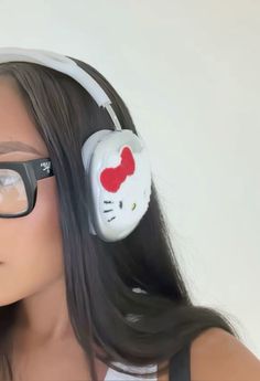 a woman wearing hello kitty headphones and glasses