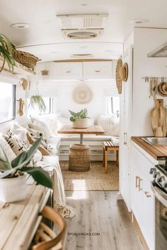 the inside of a camper with white furniture