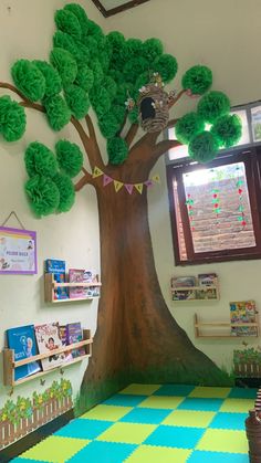 a tree with lots of green leaves on it in the corner of a school room