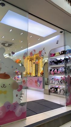 a hello kitty store front with many items in the display case and on the floor