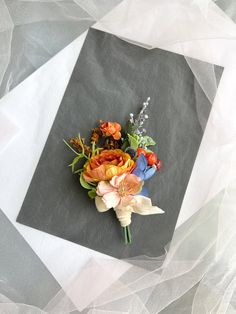 a bouquet of flowers sitting on top of a piece of cloth