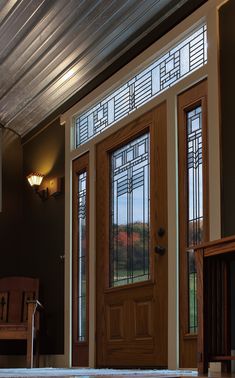 a wooden front door with glass panels on it