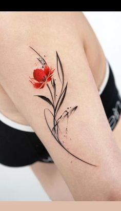 a woman's arm with a red flower tattoo on the left side of her body