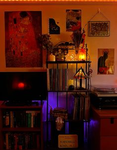 a record player sitting on top of a table next to a shelf filled with records