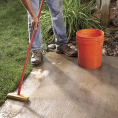 a man with a mop and bucket on the ground