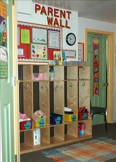 a child's room with toys and bookshelves on the wall next to a green door