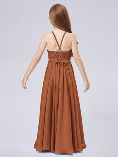 the back of a woman's brown dress with straps and laces on it