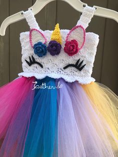 a close up of a dress made to look like a unicorn's head with flowers on it