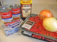 an assortment of ingredients are displayed on a kitchen counter top, including meat and vegetables