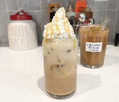 there is a drink with whipped cream on the top and caramel in the bottom