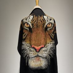 a black jacket with an image of a tiger on it