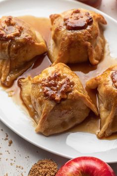 apples and cinnamon baked pastries on a white plate