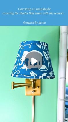 a blue lamp shade with an elephant on it and the words covering a lampshade