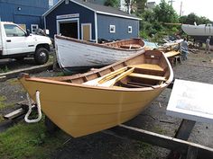 several boats are parked on the ground in front of a building