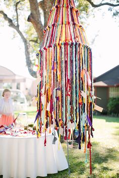 a table that has some kind of decoration hanging from it's side on the grass