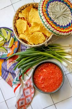 mexican food including guacamole, tortilla chips and green beans