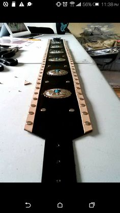 a close up of a guitar neck on a table with other instruments in the background