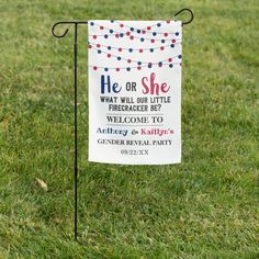 a sign that is in the grass with some string lights on it and an american flag