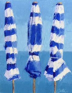 three blue and white striped umbrellas are in front of the ocean on a sunny day