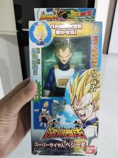 a hand holding up a dragon ball action figure