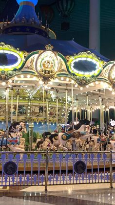 a merry go round at night with lights on