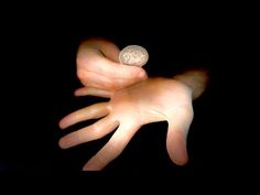 a person's hand reaching for a coin in the dark