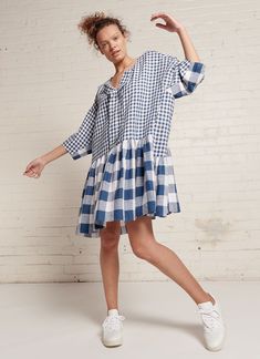 The Margatta Dress is an easy-fit, knee-length dress with centre front pleat and gathered detailing that gives fullness and drape along the body. It features an open neckline and ¾ sleeves. It features a stunning mix of small and large gingham yarn dye washed linen that is especially woven for us in India. It also comes in plain colourways: White, Denim, Indigo and Pearl Blue. The garment was designed, pattern made and sampled in our Haberfield Studio in Sydney, Australia and then hand cut and crafted in New Delhi, India. Details, Textile & Composition Mixed Gingham Yarn Dye Washed Linen 100% Linen Size & Fit The Margatta Dress is available in One Size Easy Fit. It is designed to fit AU sizes 8-18. Model’s height is 178 cm. Female model wears One Size Easy Fit and is usually a standard Siz Resort Lookbook, Slow Clothing, Gingham Linen, Upcycle Shirt, Resort Fashion, Gathered Dress, Shirt Refashion, Cut Dress, Studio Photoshoot