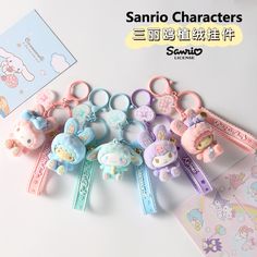 sanrio character keychains are displayed on a white surface with other items in the background