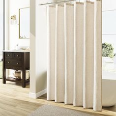 a bath room with a tub and a shower curtain