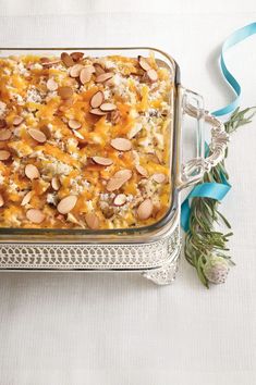 a casserole dish with almonds and other toppings