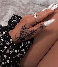 a woman's hand with a tattoo on it